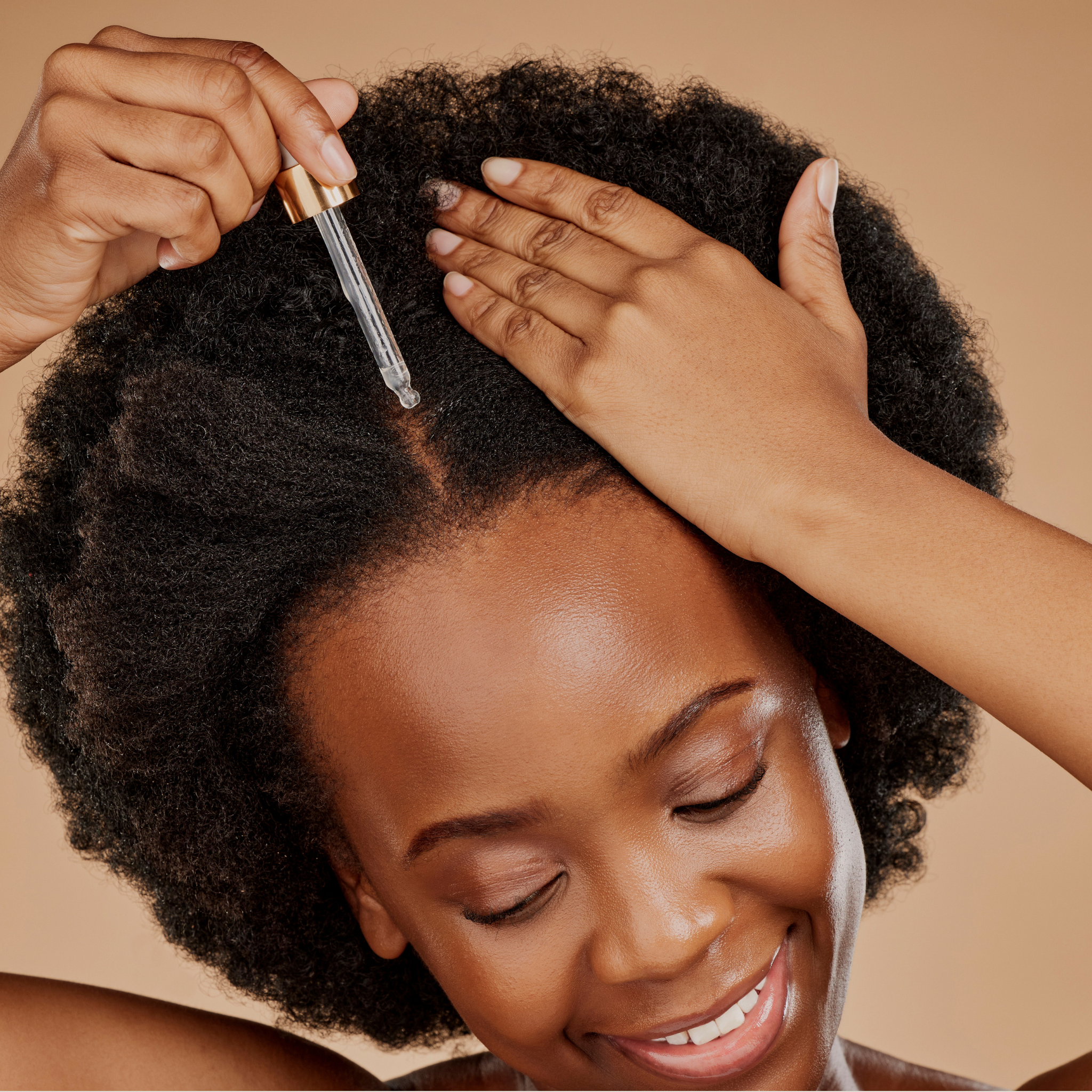 woman applying hair oil